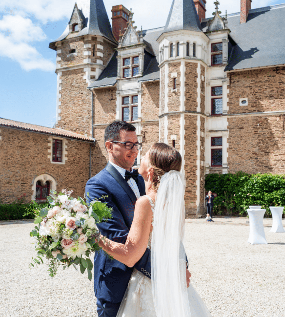 bride and groom in front of a castle